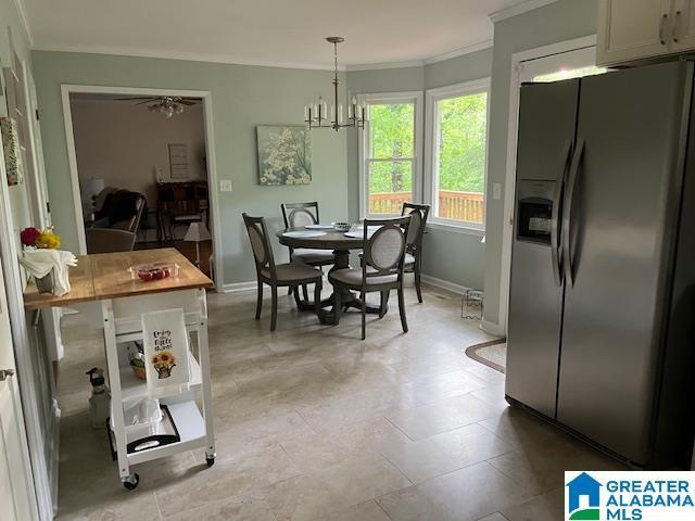 dining room with crown molding, baseboards, and ceiling fan with notable chandelier