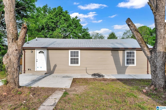 300 6th St, Docena, AL 35060 - view of front of house featuring metal roof and a patio