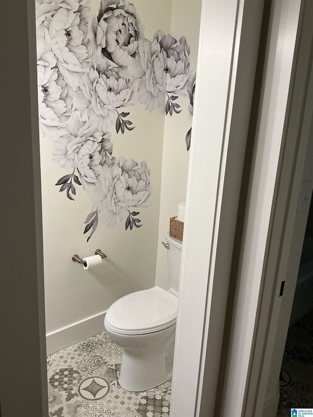 bathroom with toilet and tile patterned floors