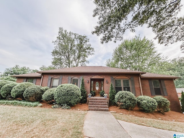ranch-style home featuring brick siding