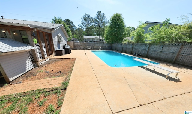 view of swimming pool featuring a fenced backyard, a fenced in pool, area for grilling, and a patio