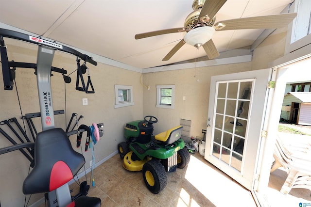 workout room featuring a ceiling fan and tile patterned flooring