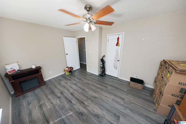 interior space with wood finished floors, baseboards, and ceiling fan