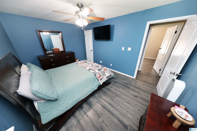 bedroom with baseboards, a ceiling fan, and dark wood-style floors