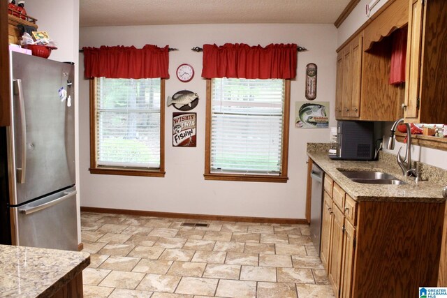 kitchen featuring a wealth of natural light, visible vents, stainless steel appliances, and a sink