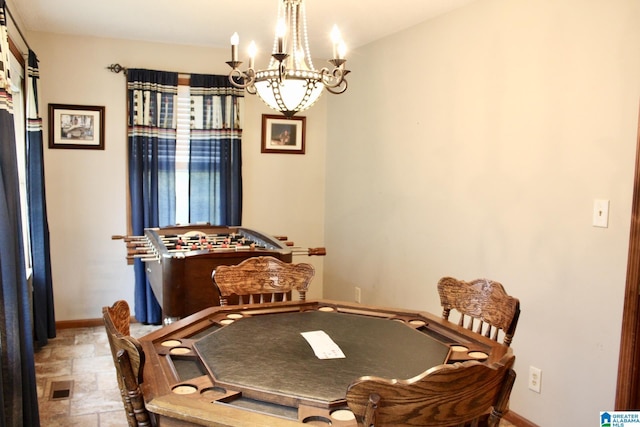 dining room featuring visible vents, a notable chandelier, and baseboards