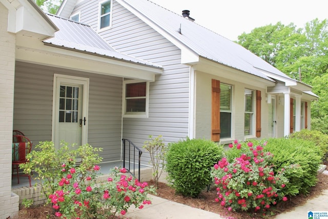 property entrance featuring metal roof