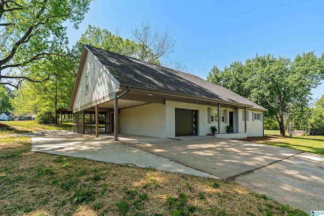 1515 Spring St, Alexander City, AL 35010 - view of front of home featuring driveway, a shingled roof, and a carport