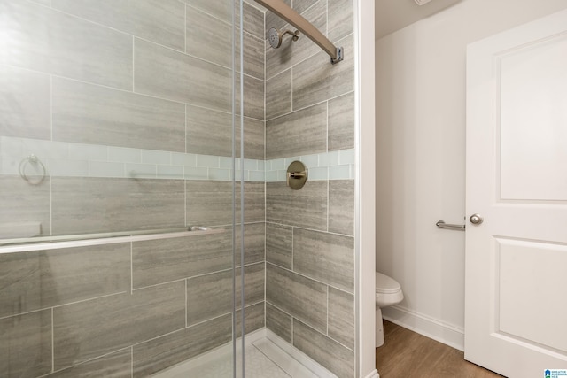 1515 Spring St, Alexander City, AL 35010 - full bathroom featuring a shower stall, toilet, baseboards, and wood finished floors