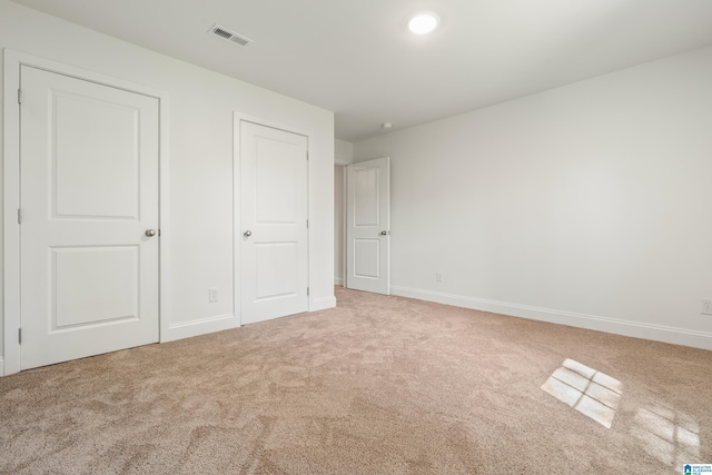 1515 Spring St, Alexander City, AL 35010 - unfurnished bedroom with baseboards, carpet flooring, and visible vents