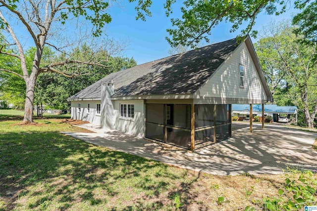 1515 Spring St, Alexander City, AL 35010 - back of house with a shingled roof, a sunroom, and a yard