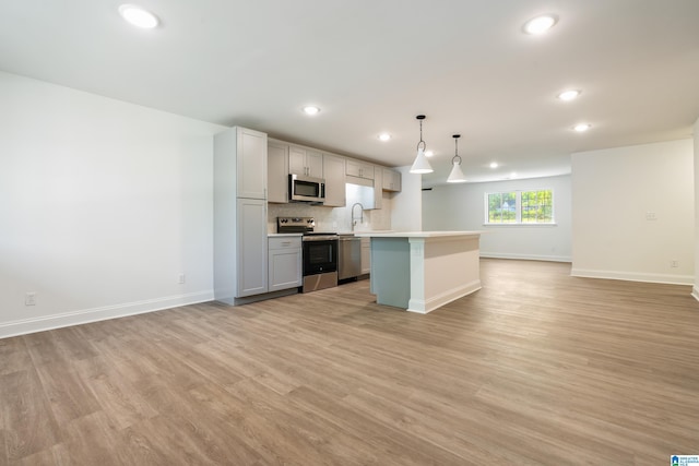 1515 Spring St, Alexander City, AL 35010 - kitchen featuring open floor plan, baseboards, recessed lighting, light countertops, and appliances with stainless steel finishes