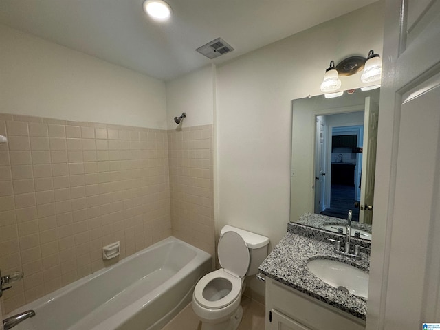 bathroom featuring visible vents, toilet, vanity, baseboards, and shower / tub combination