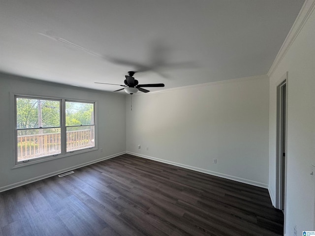 spare room featuring a ceiling fan, baseboards, ornamental molding, dark wood-type flooring, and visible vents