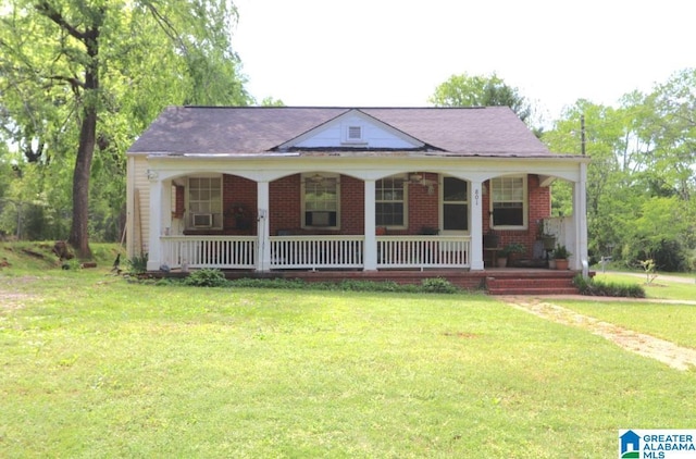 801 Walnut St, Talladega, AL 35160 - bungalow with brick siding, a porch, and a front lawn