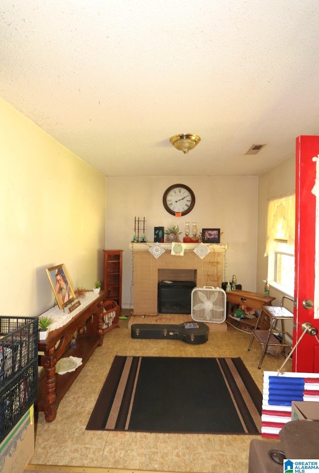 801 Walnut St, Talladega, AL 35160 - living area with carpet, visible vents, and a fireplace