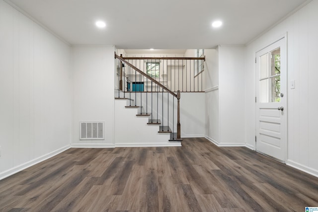 interior space with baseboards, stairs, wood finished floors, and visible vents