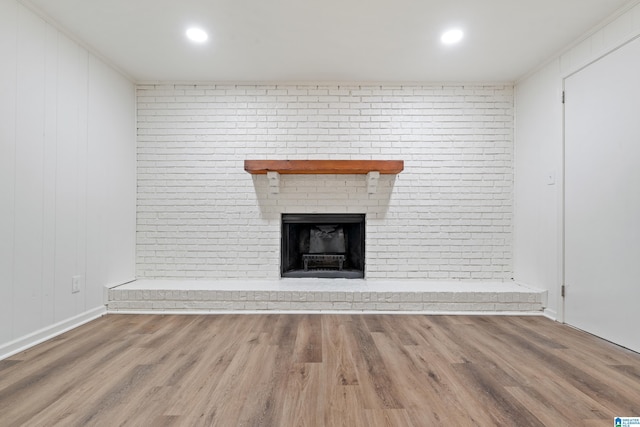 unfurnished living room with baseboards, a fireplace, recessed lighting, and wood finished floors