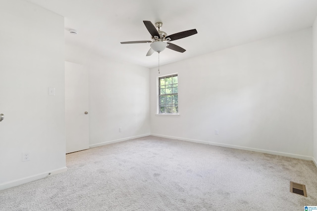 spare room featuring visible vents, a ceiling fan, carpet, and baseboards