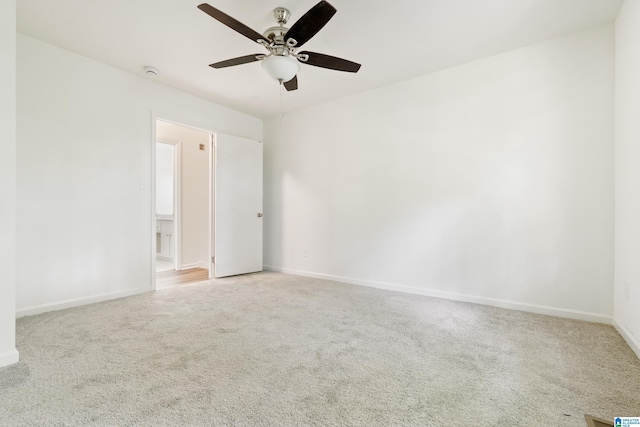 carpeted empty room with baseboards and ceiling fan