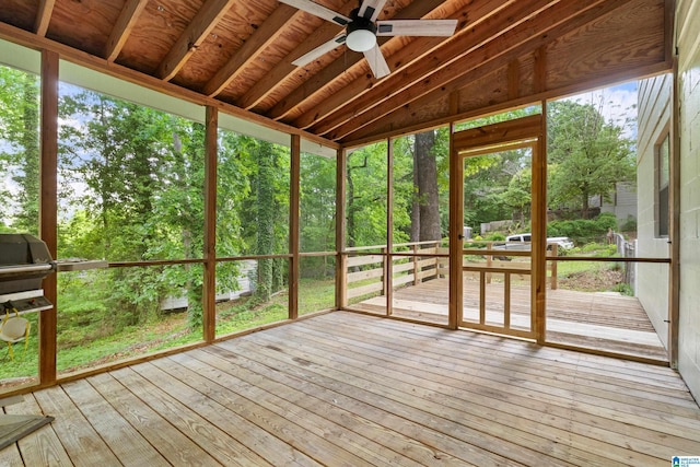 unfurnished sunroom featuring a ceiling fan