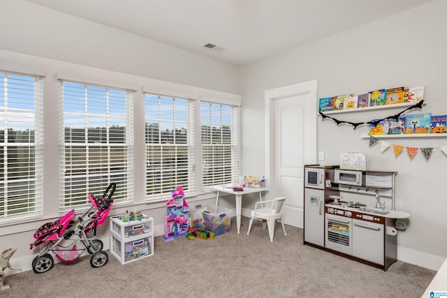 playroom with carpet flooring, baseboards, and visible vents