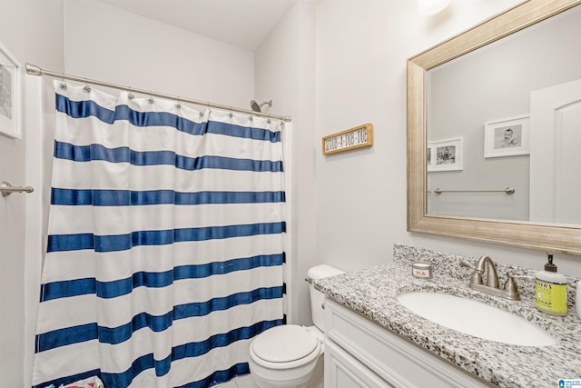 bathroom featuring toilet, curtained shower, and vanity
