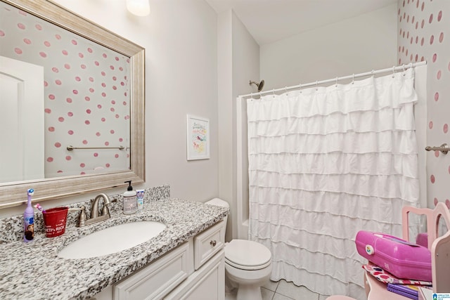 bathroom featuring toilet, shower / bath combination with curtain, tile patterned flooring, and vanity