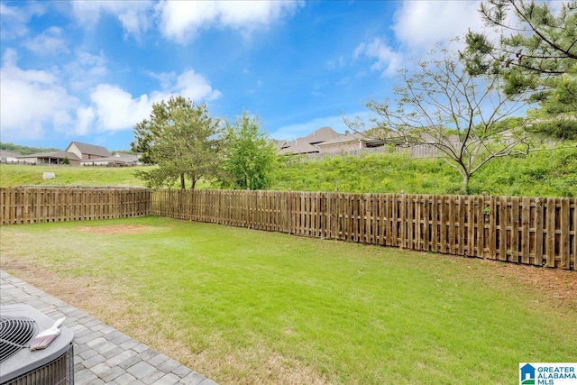 view of yard featuring cooling unit, a residential view, and a fenced backyard