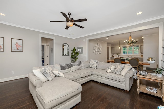 living room with baseboards, dark wood-style flooring, recessed lighting, ornamental molding, and ceiling fan with notable chandelier