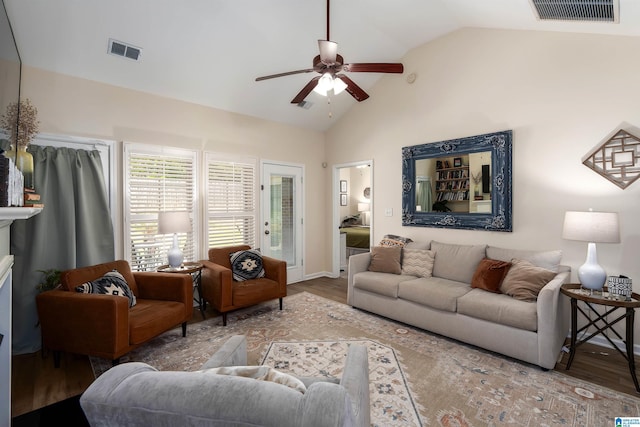 living area featuring a ceiling fan, visible vents, high vaulted ceiling, and wood finished floors