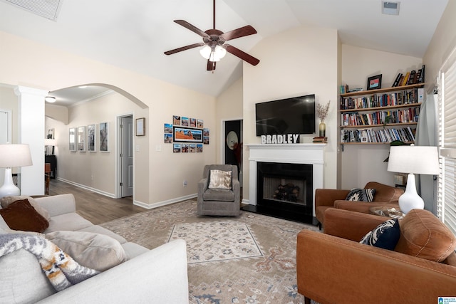living room featuring a fireplace, visible vents, a ceiling fan, and arched walkways
