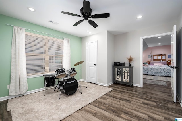 interior space featuring visible vents, ceiling fan, wood finished floors, and baseboards