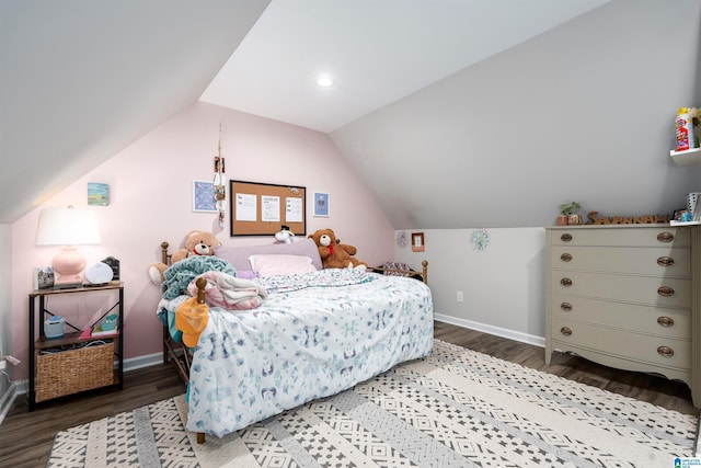 bedroom featuring baseboards, wood finished floors, and vaulted ceiling
