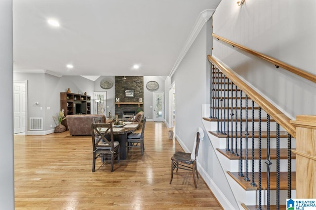 dining space featuring visible vents, ornamental molding, stairs, and baseboards