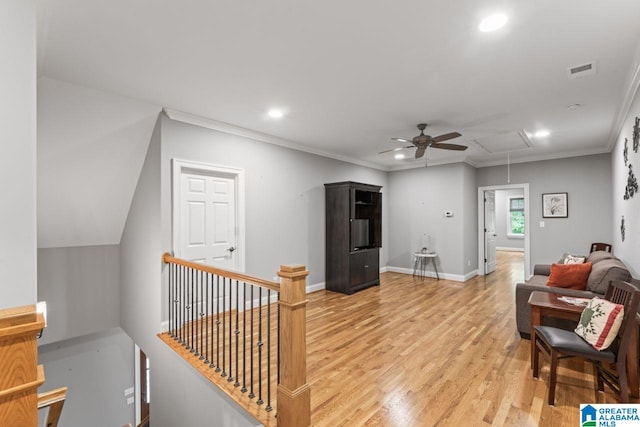 living area with attic access, recessed lighting, light wood-style floors, ceiling fan, and visible vents