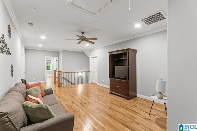 living area featuring attic access, crown molding, recessed lighting, and visible vents