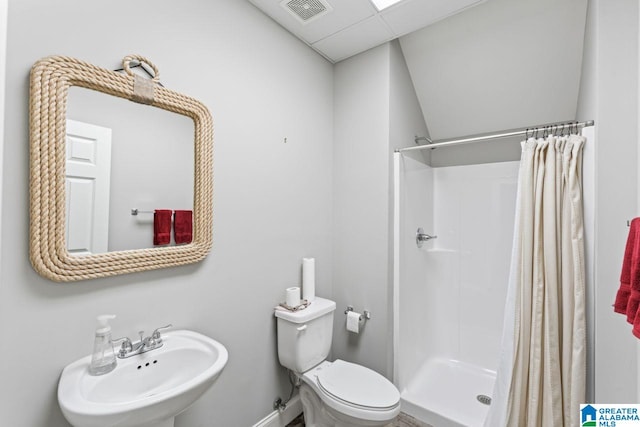 full bath with toilet, visible vents, a shower stall, and a sink