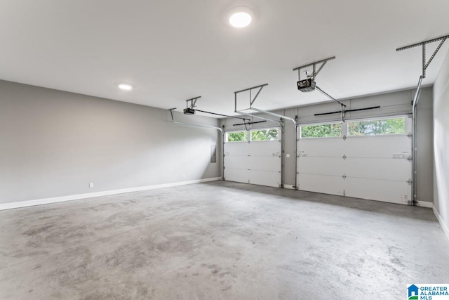 garage with a garage door opener and baseboards
