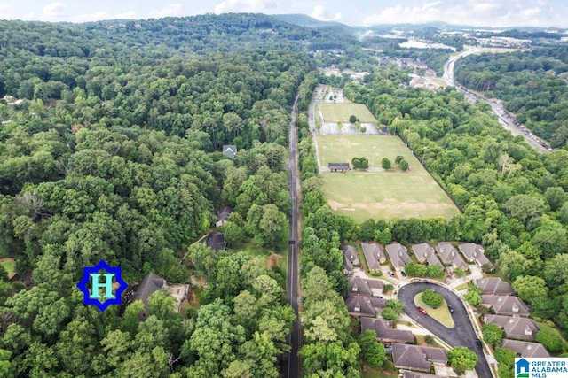 drone / aerial view featuring a view of trees