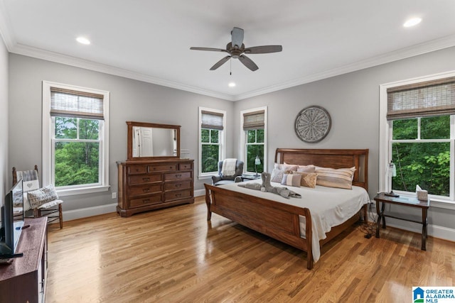 bedroom with baseboards, ornamental molding, and light wood-style floors