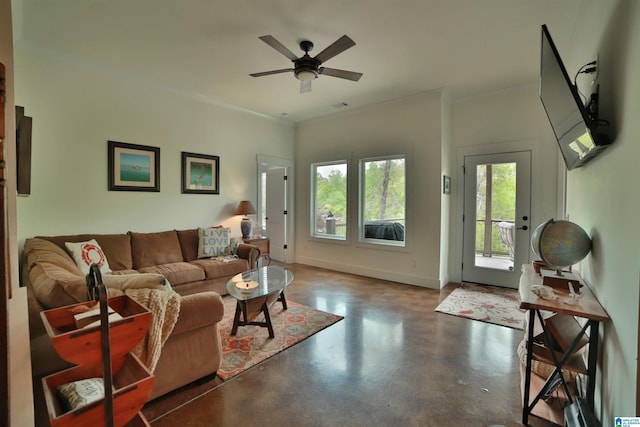 living area with baseboards, visible vents, ceiling fan, and finished concrete flooring
