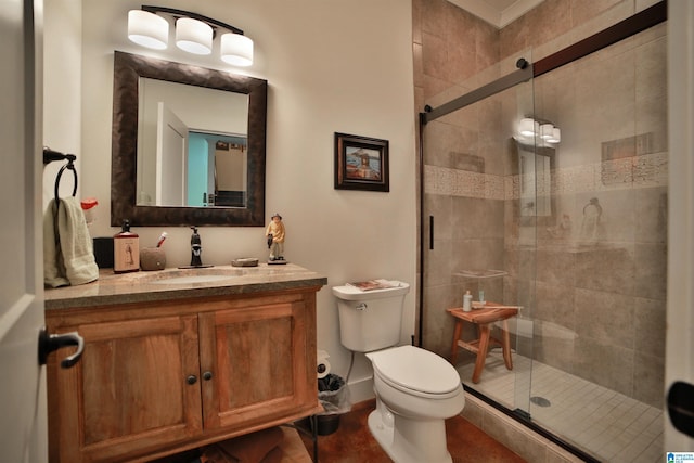 bathroom featuring a stall shower, toilet, and vanity