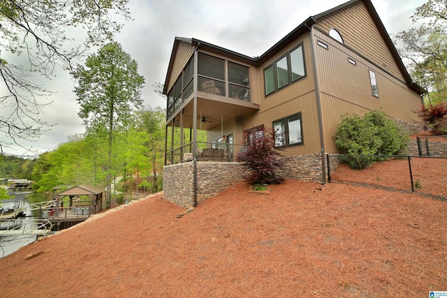 back of house featuring fence, a gazebo, and ceiling fan
