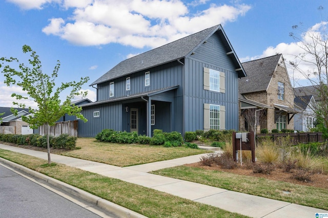 1298 Claire Ter, Hoover, AL 35244 - view of front of house featuring a shingled roof, a front lawn, board and batten siding, and fence