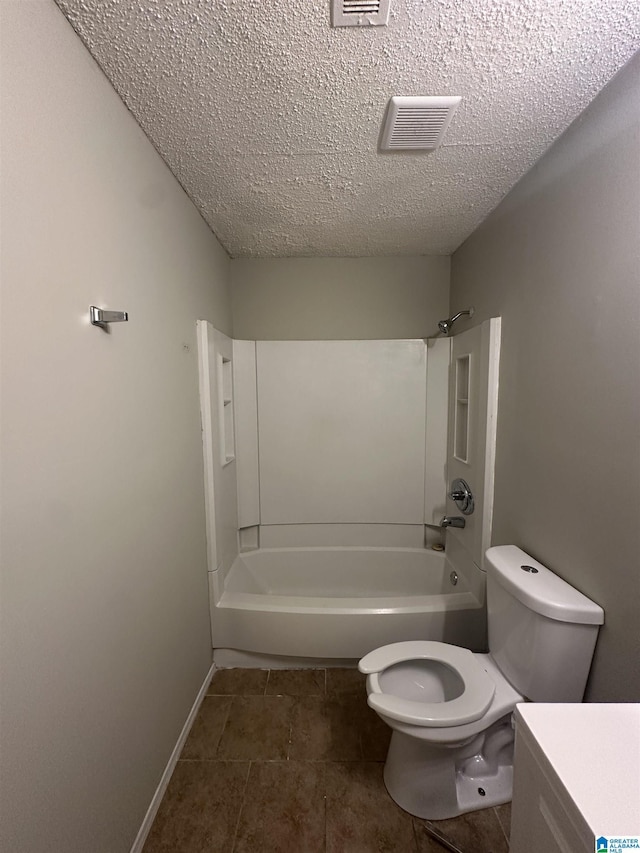 bathroom featuring washtub / shower combination, tile patterned floors, visible vents, toilet, and a textured ceiling