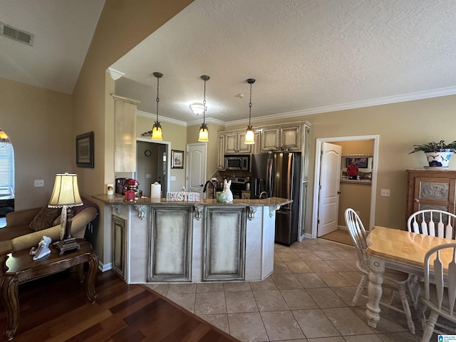 5050 Lily Rd, Hokes Bluff, AL 35903 - kitchen with stainless steel appliances, a peninsula, visible vents, stone countertops, and hanging light fixtures