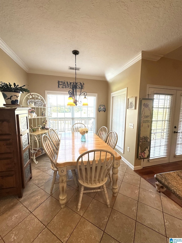 5050 Lily Rd, Hokes Bluff, AL 35903 - dining space with tile patterned floors, visible vents, crown molding, baseboards, and a textured ceiling