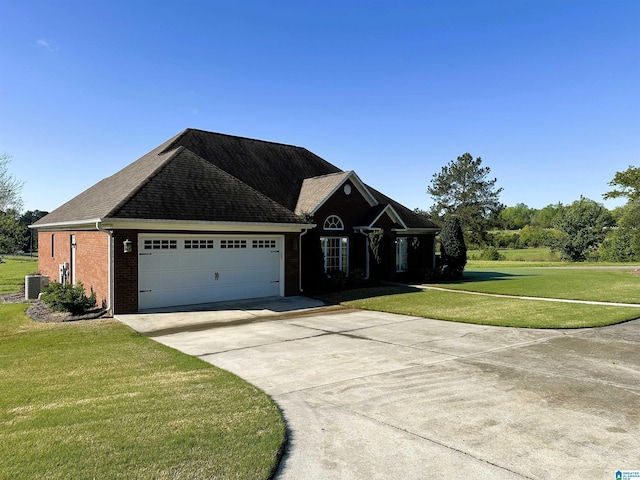 5050 Lily Rd, Hokes Bluff, AL 35903 - view of front facade featuring central AC unit, a front lawn, driveway, an attached garage, and brick siding