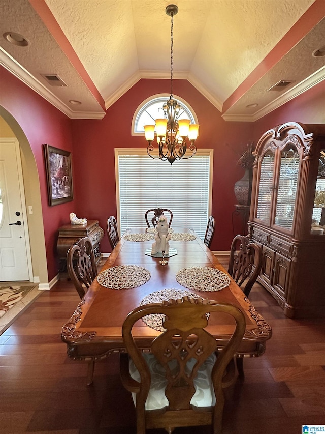 5050 Lily Rd, Hokes Bluff, AL 35903 - dining space featuring arched walkways, vaulted ceiling, visible vents, a notable chandelier, and wood finished floors